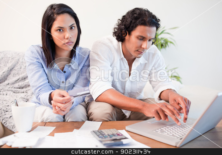 To use this stock image in your creative project, please select the size you need over to the right and click the "Add to Cart" button.
Your downloaded image will come with the Cutcaster watermark removed so don’t worry about the watermark you see on this page. Couple checking their bank accounts online in the living room stock photo, Young couple checking their bank accounts online in the living room by Wavebreak Media