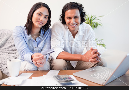 To use this stock image in your creative project, please select the size you need over to the right and click the "Add to Cart" button.
Your downloaded image will come with the Cutcaster watermark removed so don’t worry about the watermark you see on this page. Couple doing online banking in the living room stock photo, Young couple doing online banking in the living room by Wavebreak Media