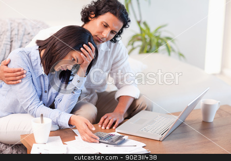 To use this stock image in your creative project, please select the size you need over to the right and click the "Add to Cart" button.
Your downloaded image will come with the Cutcaster watermark removed so don’t worry about the watermark you see on this page. Side view of couple having a hard time paying their bills stock photo, Side view of young couple having a hard time paying their bills by Wavebreak Media