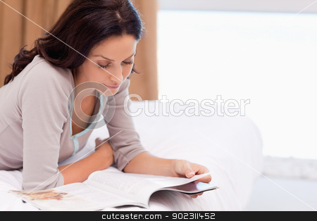 To use this stock image in your creative project, please select the size you need over to the right and click the "Add to Cart" button.
Your downloaded image will come with the Cutcaster watermark removed so don’t worry about the watermark you see on this page. Woman reading magazine on the bed stock photo, Young woman reading magazine on the bed by Wavebreak Media