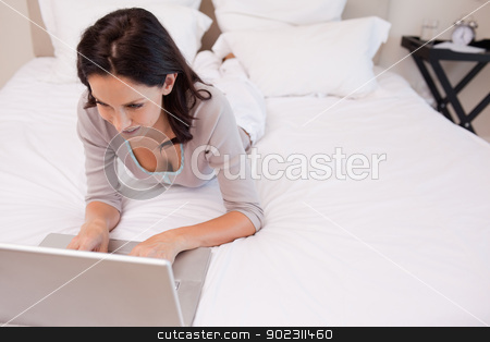 To use this stock image in your creative project, please select the size you need over to the right and click the "Add to Cart" button.
Your downloaded image will come with the Cutcaster watermark removed so don’t worry about the watermark you see on this page. Woman lying on the bed using her laptop stock photo, Young woman lying on the bed using her laptop by Wavebreak Media