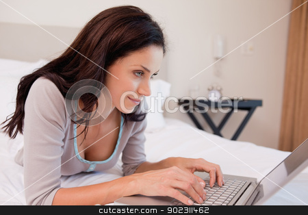 To use this stock image in your creative project, please select the size you need over to the right and click the "Add to Cart" button.
Your downloaded image will come with the Cutcaster watermark removed so don’t worry about the watermark you see on this page. Woman lying on the bed using her notebook stock photo, Young woman lying on the bed using her notebook by Wavebreak Media