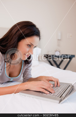 To use this stock image in your creative project, please select the size you need over to the right and click the "Add to Cart" button.
Your downloaded image will come with the Cutcaster watermark removed so don’t worry about the watermark you see on this page. Woman working on the laptop in the bedroom stock photo, Young woman working on the laptop in the bedroom by Wavebreak Media