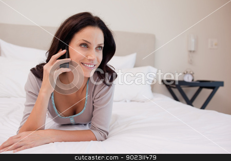 To use this stock image in your creative project, please select the size you need over to the right and click the "Add to Cart" button.
Your downloaded image will come with the Cutcaster watermark removed so don’t worry about the watermark you see on this page. Woman on the bed having a phone call stock photo, Young woman on the bed having a phone call by Wavebreak Media