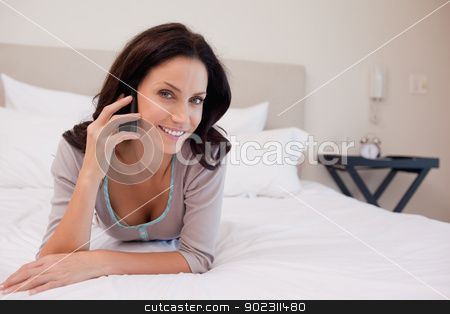 To use this stock image in your creative project, please select the size you need over to the right and click the "Add to Cart" button.
Your downloaded image will come with the Cutcaster watermark removed so don’t worry about the watermark you see on this page. Smiling woman on the bed having a phone call stock photo, Smiling young woman on the bed having a phone call by Wavebreak Media