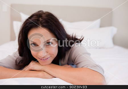 To use this stock image in your creative project, please select the size you need over to the right and click the "Add to Cart" button.
Your downloaded image will come with the Cutcaster watermark removed so don’t worry about the watermark you see on this page. Smiling woman relaxing on the bed stock photo, Smiling young woman relaxing on the bed by Wavebreak Media