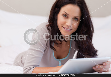 To use this stock image in your creative project, please select the size you need over to the right and click the "Add to Cart" button.
Your downloaded image will come with the Cutcaster watermark removed so don’t worry about the watermark you see on this page. Woman laying in the bedroom with tablet stock photo, Young woman laying on the bedroom with tablet by Wavebreak Media