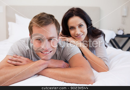 To use this stock image in your creative project, please select the size you need over to the right and click the "Add to Cart" button.
Your downloaded image will come with the Cutcaster watermark removed so don’t worry about the watermark you see on this page. Couple relaxing on the bed together stock photo, Young couple relaxing on the bed together by Wavebreak Media