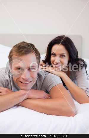 To use this stock image in your creative project, please select the size you need over to the right and click the "Add to Cart" button.
Your downloaded image will come with the Cutcaster watermark removed so don’t worry about the watermark you see on this page. Couple laying on the bed together stock photo, Young couple laying on the bed together by Wavebreak Media