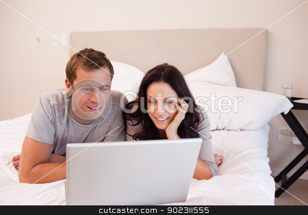 To use this stock image in your creative project, please select the size you need over to the right and click the "Add to Cart" button.
Your downloaded image will come with the Cutcaster watermark removed so don’t worry about the watermark you see on this page. Couple using laptop on the bed together stock photo, Young couple using laptop on the bed together by Wavebreak Media