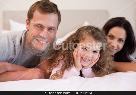 To use this stock image in your creative project, please select the size you need over to the right and click the "Add to Cart" button.
Your downloaded image will come with the Cutcaster watermark removed so don’t worry about the watermark you see on this page. Family relaxing in the bedroom together stock photo, Young family relaxing in the bedroom together by Wavebreak Media