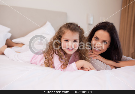 To use this stock image in your creative project, please select the size you need over to the right and click the "Add to Cart" button.
Your downloaded image will come with the Cutcaster watermark removed so don’t worry about the watermark you see on this page. Mother and daughter relaxing in the bedroom together stock photo, Young mother and daughter relaxing in the bedroom together by Wavebreak Media
