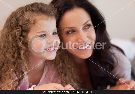 To use this stock image in your creative project, please select the size you need over to the right and click the "Add to Cart" button.
Your downloaded image will come with the Cutcaster watermark removed so don’t worry about the watermark you see on this page. Mother and daughter lying close together stock photo, Young mother and daughter lying close together by Wavebreak Media
