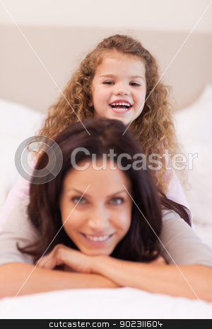 To use this stock image in your creative project, please select the size you need over to the right and click the "Add to Cart" button.
Your downloaded image will come with the Cutcaster watermark removed so don’t worry about the watermark you see on this page. Girl sitting on her mothers back stock photo, Little girl sitting on her mothers back by Wavebreak Media