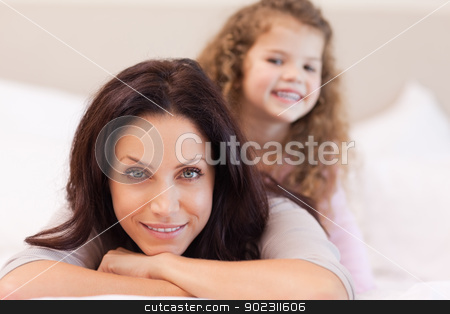 To use this stock image in your creative project, please select the size you need over to the right and click the "Add to Cart" button.
Your downloaded image will come with the Cutcaster watermark removed so don’t worry about the watermark you see on this page. Mother and daughter relaxing on the bed stock photo, Young mother and daughter relaxing on the bed by Wavebreak Media