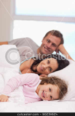 To use this stock image in your creative project, please select the size you need over to the right and click the "Add to Cart" button.
Your downloaded image will come with the Cutcaster watermark removed so don’t worry about the watermark you see on this page. Family lying on the bed together stock photo, Young family lying on the bed together by Wavebreak Media
