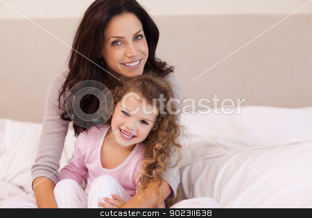 To use this stock image in your creative project, please select the size you need over to the right and click the "Add to Cart" button.
Your downloaded image will come with the Cutcaster watermark removed so don’t worry about the watermark you see on this page. Mother hugging her daughter on the bed stock photo, Young mother hugging her daughter on the bed by Wavebreak Media