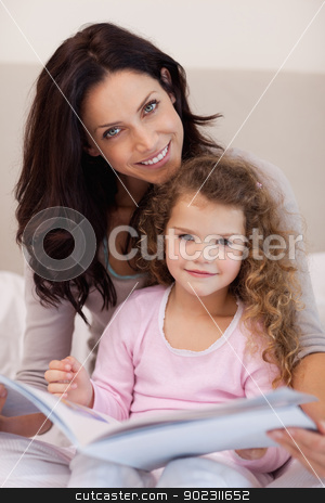 To use this stock image in your creative project, please select the size you need over to the right and click the "Add to Cart" button.
Your downloaded image will come with the Cutcaster watermark removed so don’t worry about the watermark you see on this page. Smiling mother reading a bedtime story with her little daughter stock photo, Smiling young mother reading a bedtime story with her little daughter by Wavebreak Media