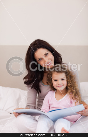 To use this stock image in your creative project, please select the size you need over to the right and click the "Add to Cart" button.
Your downloaded image will come with the Cutcaster watermark removed so don’t worry about the watermark you see on this page. Mother and daughter reading a book on the bed stock photo, Young mother and daughter reading a book together on the bed by Wavebreak Media