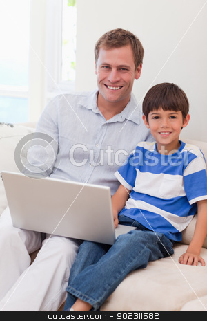 To use this stock image in your creative project, please select the size you need over to the right and click the "Add to Cart" button.
Your downloaded image will come with the Cutcaster watermark removed so don’t worry about the watermark you see on this page. Smiling father and son surfing the internet together stock photo, Smiling young father and son surfing the internet together by Wavebreak Media
