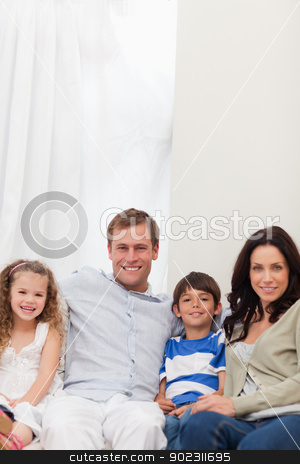 To use this stock image in your creative project, please select the size you need over to the right and click the "Add to Cart" button.
Your downloaded image will come with the Cutcaster watermark removed so don’t worry about the watermark you see on this page. Smiling family sitting on the sofa together stock photo, Smiling young family sitting on the sofa together by Wavebreak Media
