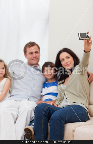 To use this stock image in your creative project, please select the size you need over to the right and click the "Add to Cart" button.
Your downloaded image will come with the Cutcaster watermark removed so don’t worry about the watermark you see on this page. Mother taking family photograph on the sofa stock photo, Young mother taking family photograph on the sofa by Wavebreak Media