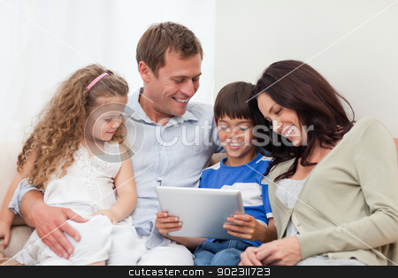 To use this stock image in your creative project, please select the size you need over to the right and click the "Add to Cart" button.
Your downloaded image will come with the Cutcaster watermark removed so don’t worry about the watermark you see on this page. Family using tablet on the sofa stock photo, Young family using tablet on the sofa by Wavebreak Media