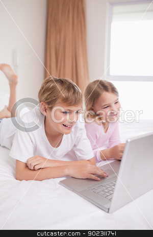 To use this stock image in your creative project, please select the size you need over to the right and click the "Add to Cart" button.
Your downloaded image will come with the Cutcaster watermark removed so don’t worry about the watermark you see on this page. Portrait of children using a notebook stock photo, Portrait of children using a notebook in a bedroom by Wavebreak Media
