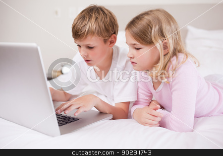 To use this stock image in your creative project, please select the size you need over to the right and click the "Add to Cart" button.
Your downloaded image will come with the Cutcaster watermark removed so don’t worry about the watermark you see on this page. Cute children using a laptop stock photo, Cute children using a laptop in a bedroom by Wavebreak Media