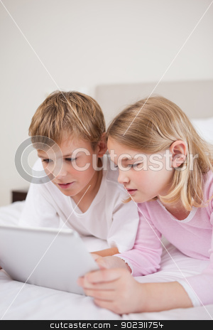 To use this stock image in your creative project, please select the size you need over to the right and click the "Add to Cart" button.
Your downloaded image will come with the Cutcaster watermark removed so don’t worry about the watermark you see on this page. Portrait of cute children using a tablet computer stock photo, Portrait of cute children using a tablet computer in a bedroom by Wavebreak Media