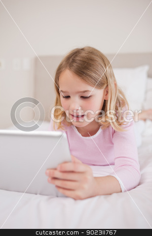 To use this stock image in your creative project, please select the size you need over to the right and click the "Add to Cart" button.
Your downloaded image will come with the Cutcaster watermark removed so don’t worry about the watermark you see on this page. Portrait of a little girl using a tablet computer stock photo, Portrait of a little girl using a tablet computer in a bedroom by Wavebreak Media