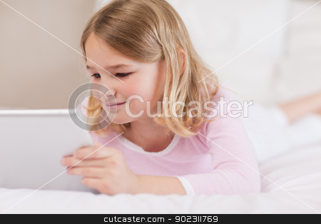 To use this stock image in your creative project, please select the size you need over to the right and click the "Add to Cart" button.
Your downloaded image will come with the Cutcaster watermark removed so don’t worry about the watermark you see on this page. Cute girl using a tablet computer stock photo, Cute girl using a tablet computer in her bedroom by Wavebreak Media