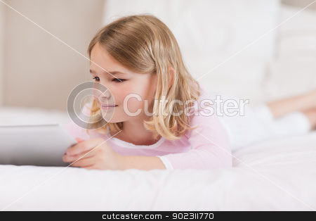 To use this stock image in your creative project, please select the size you need over to the right and click the "Add to Cart" button.
Your downloaded image will come with the Cutcaster watermark removed so don’t worry about the watermark you see on this page. Child using a tablet computer stock photo, Child using a tablet computer in a bedroom by Wavebreak Media