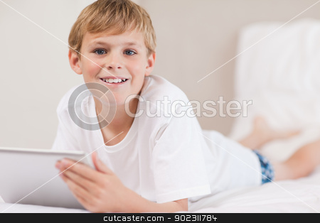 To use this stock image in your creative project, please select the size you need over to the right and click the "Add to Cart" button.
Your downloaded image will come with the Cutcaster watermark removed so don’t worry about the watermark you see on this page. Boy using a tablet computer stock photo, Boy using a tablet computer in a bedroom by Wavebreak Media