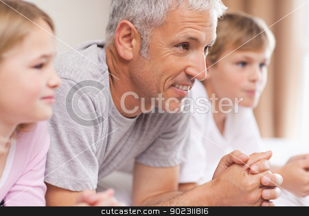 To use this stock image in your creative project, please select the size you need over to the right and click the "Add to Cart" button.
Your downloaded image will come with the Cutcaster watermark removed so don’t worry about the watermark you see on this page. Father and his children lying on a bed stock photo, Father and his children lying on a bed looking away from the camera by Wavebreak Media