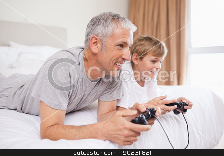 To use this stock image in your creative project, please select the size you need over to the right and click the "Add to Cart" button.
Your downloaded image will come with the Cutcaster watermark removed so don’t worry about the watermark you see on this page. Smiling father and his son playing video games stock photo, Smiling father and his son playing video games in a bedroom by Wavebreak Media
