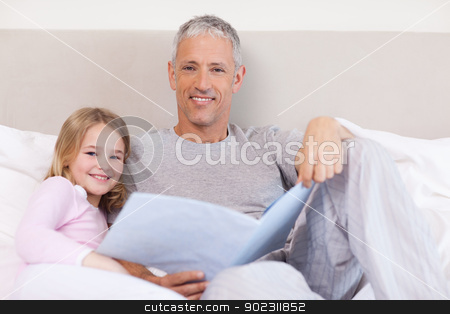 To use this stock image in your creative project, please select the size you need over to the right and click the "Add to Cart" button.
Your downloaded image will come with the Cutcaster watermark removed so don’t worry about the watermark you see on this page. Smiling father reading a story to his daughter stock photo, Smiling father reading a story to his daughter in a bedroom by Wavebreak Media