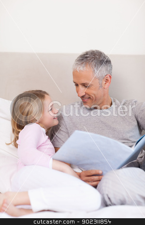 To use this stock image in your creative project, please select the size you need over to the right and click the "Add to Cart" button.
Your downloaded image will come with the Cutcaster watermark removed so don’t worry about the watermark you see on this page. Portrait of a smiling father reading a story to his daughter stock photo, Portrait of a smiling father reading a story to his daughter in a bedroom by Wavebreak Media