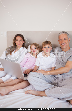 To use this stock image in your creative project, please select the size you need over to the right and click the "Add to Cart" button.
Your downloaded image will come with the Cutcaster watermark removed so don’t worry about the watermark you see on this page. Portrait of a family using a laptop stock photo, Portrait of a family using a laptop in a bedroom by Wavebreak Media