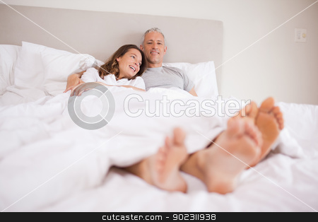 To use this stock image in your creative project, please select the size you need over to the right and click the "Add to Cart" button.
Your downloaded image will come with the Cutcaster watermark removed so don’t worry about the watermark you see on this page. Charming couple lying in a bed stock photo, Charming couple lying in a bed while hugging by Wavebreak Media