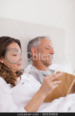 To use this stock image in your creative project, please select the size you need over to the right and click the "Add to Cart" button.
Your downloaded image will come with the Cutcaster watermark removed so don’t worry about the watermark you see on this page. Portrait of a woman reading a book while her husband is reading stock photo, Portrait of a woman reading a book while her husband is reading a newspaper in their bedroom by Wavebreak Media