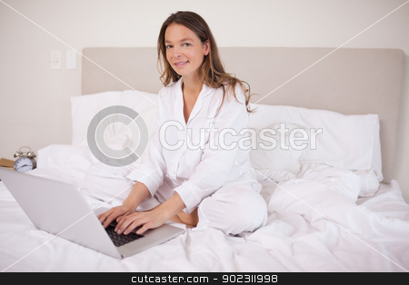 To use this stock image in your creative project, please select the size you need over to the right and click the "Add to Cart" button.
Your downloaded image will come with the Cutcaster watermark removed so don’t worry about the watermark you see on this page. Woman using a laptop stock photo, Woman using a laptop in her bedroom by Wavebreak Media