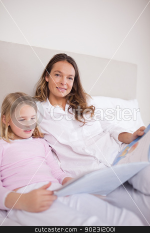 To use this stock image in your creative project, please select the size you need over to the right and click the "Add to Cart" button.
Your downloaded image will come with the Cutcaster watermark removed so don’t worry about the watermark you see on this page. Portrait of a girl reading a book with her mother stock photo, Portrait of a girl reading a book with her mother in a bedroom by Wavebreak Media
