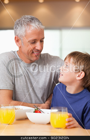 To use this stock image in your creative project, please select the size you need over to the right and click the "Add to Cart" button.
Your downloaded image will come with the Cutcaster watermark removed so don’t worry about the watermark you see on this page. Portrait of a young boy and his father having breakfast stock photo, Portrait of a young boy and his father having breakfast in a kitchen by Wavebreak Media