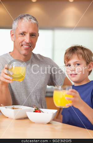 To use this stock image in your creative project, please select the size you need over to the right and click the "Add to Cart" button.
Your downloaded image will come with the Cutcaster watermark removed so don’t worry about the watermark you see on this page. Portrait of a cute boy and his father having breakfast stock photo, Portrait of a cute boy and his father having breakfast in a kitchen by Wavebreak Media