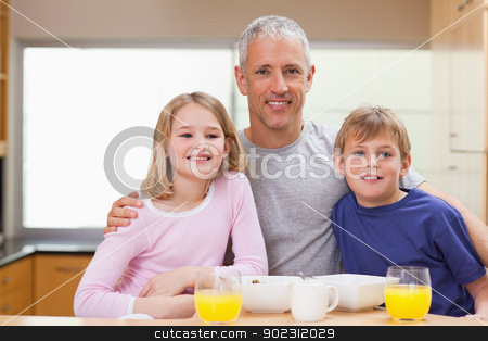 To use this stock image in your creative project, please select the size you need over to the right and click the "Add to Cart" button.
Your downloaded image will come with the Cutcaster watermark removed so don’t worry about the watermark you see on this page. Smiling father posing with his children in the morning stock photo, Smiling father posing with his children in the morning in a kitchen by Wavebreak Media