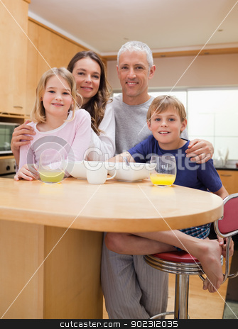 To use this stock image in your creative project, please select the size you need over to the right and click the "Add to Cart" button.
Your downloaded image will come with the Cutcaster watermark removed so don’t worry about the watermark you see on this page. Portrait of a smiling family having breakfast stock photo, Portrait of a smiling family having breakfast in their kitchen by Wavebreak Media