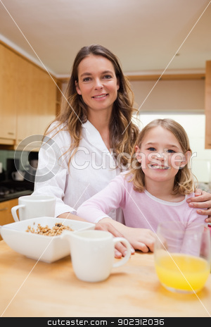 To use this stock image in your creative project, please select the size you need over to the right and click the "Add to Cart" button.
Your downloaded image will come with the Cutcaster watermark removed so don’t worry about the watermark you see on this page. Portrait of a mother and her daughter having breakfast stock photo, Portrait of a mother and her daughter having breakfast in a kitchen by Wavebreak Media
