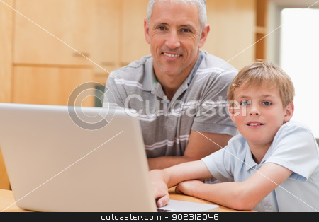 To use this stock image in your creative project, please select the size you need over to the right and click the "Add to Cart" button.
Your downloaded image will come with the Cutcaster watermark removed so don’t worry about the watermark you see on this page. Young boy and his father using a laptop stock photo, Young boy and his father using a laptop in a kitchen by Wavebreak Media