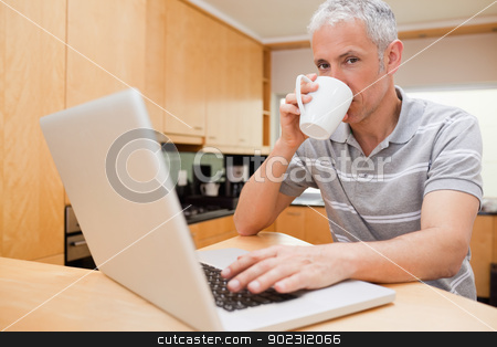 To use this stock image in your creative project, please select the size you need over to the right and click the "Add to Cart" button.
Your downloaded image will come with the Cutcaster watermark removed so don’t worry about the watermark you see on this page. Man using a notebook while drinking coffee stock photo, Man using a notebook while drinking coffee in a kitchen by Wavebreak Media